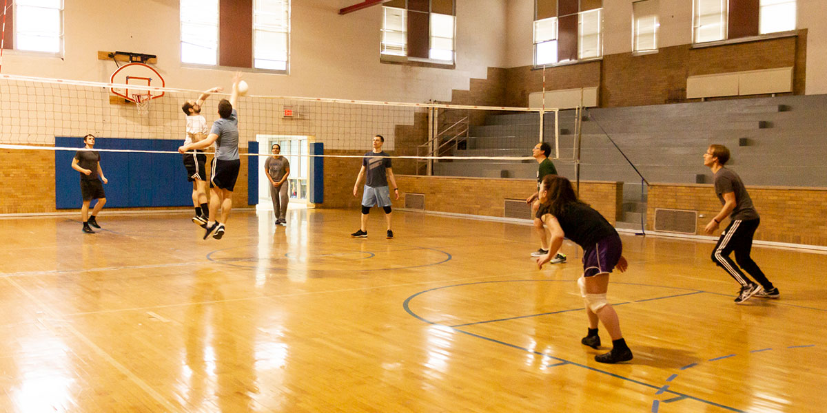 Engineers playing volleyball in the QSAI gym